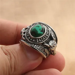 Detail of vintage signet ring with green oval stone and bull head relief decoration
