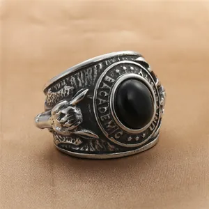 Detail of vintage steel ring with black gemstone and Academic engraving on band