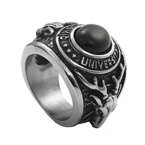 Detail of vintage signet ring with black stone, university text and stag head carving