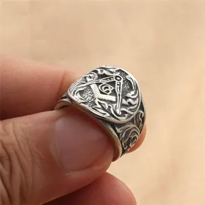 Gros plan sur la bague maçonnique en acier rétro avec compas, équerre et symbole G