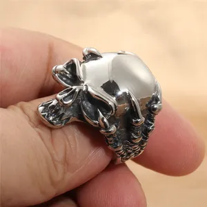 Detailed view of punk style silver skull ring showing intricate gothic metal textures
