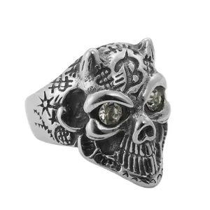 Close-up of vintage punk skull ring with star patterns and gemstone eyes