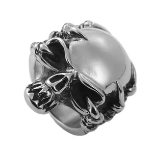 Retro punk skull ring in silver stainless steel with dragon claw design on white background