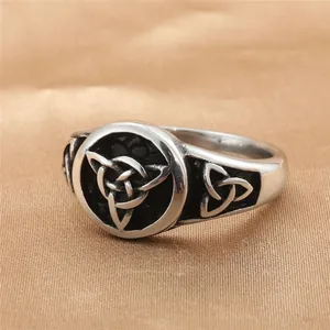 Vintage Celtic Knot stainless steel ring with oxidized finish on gold satin background