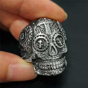 Macro shot of retro stainless steel skull ring with cross engraving and gothic finish