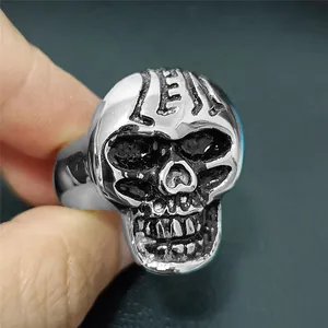 Macro detail of vintage skull ring with LEFT engraving in polished stainless steel