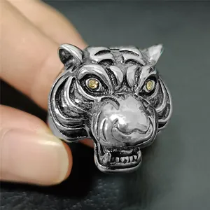 Macro detail of retro tiger head steel ring with yellow gemstone eyes and vintage texture