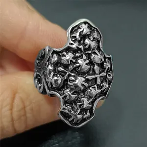 Macro shot of vintage skull and cross relief detail on punk stainless steel ring