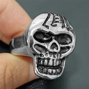 Detail of vintage punk skull ring in silver stainless steel with 231 forehead engraving