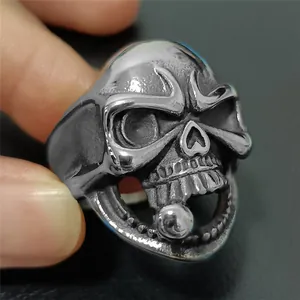 Detail of retro punk skull ring with polished metal ball and antique silver finish