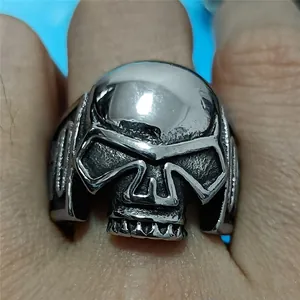 Macro detail of retro skull ring in stainless steel with vintage punk finish on finger