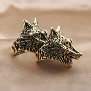Macro detail of retro wolf head ring with intricate textures and red zircon eyes