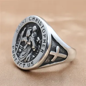 Macro detail of silver St. Christopher signet ring with engraved prayer and cross