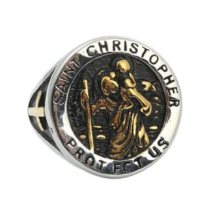 Macro detail of vintage Saint Christopher ring with embossed gold cross on stainless steel