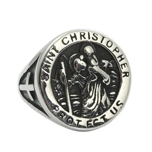 Macro shot of Saint Christopher relief and cross detail on vintage steel ring