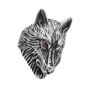 Macro detail of punk wolf head ring with vintage textured fur and red crystal eyes