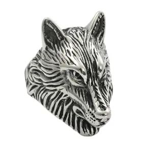 Retro punk wolf head ring in stainless steel with detailed fur texture on white background
