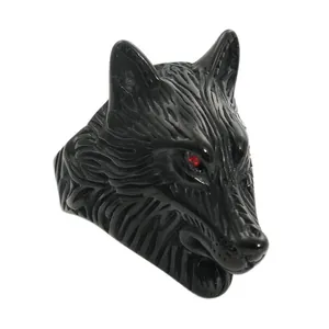 Close-up of black wolf head ring with detailed fur texture and red crystal eyes