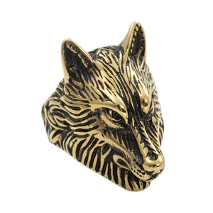 Macro side view of vintage wolf head ring with gold plating and antique black textures