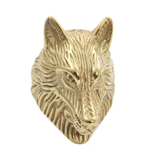 Macro detail of golden stainless steel wolf head ring with intricate 3D carved textures