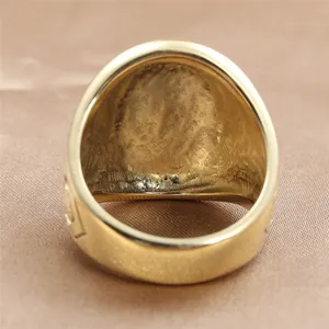 Macro detail of gold vintage eagle signet ring showing polished surface and inner texture