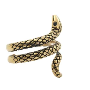 Macro view of gold snake ring featuring detailed scales and a black stone eye embellishment