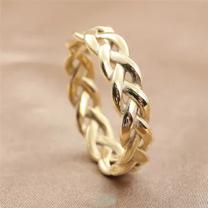 Macro detail of gold braided texture ring on luxurious brown silk background
