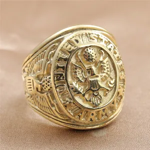 Macro detail of golden United States Army signet ring with eagle crest on brown silk
