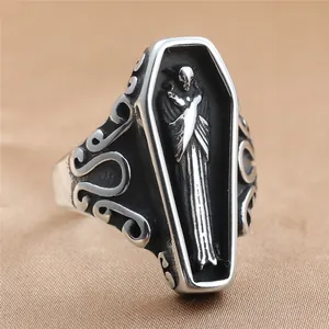 Macro view of gothic steel coffin ring with detailed skull relief and vintage finish