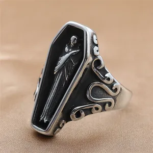Macro shot of punk gothic coffin ring featuring carved skull and vintage scrollwork