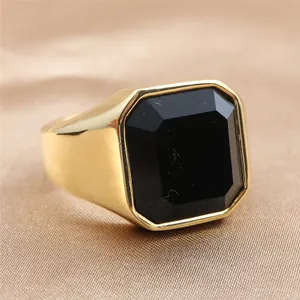 Macro shot of a vintage gold ring featuring a large octagonal cut black gemstone