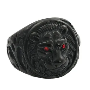 Detail of matte black lion head ring with striking red gemstone eyes for men