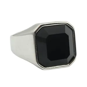 Macro detail of men's vintage steel ring featuring a large black octagonal gemstone