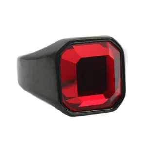Macro view of a large emerald-cut red gemstone set in a matte black stainless steel ring