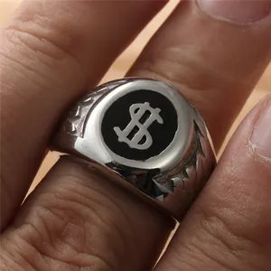 Close-up of a punk style stainless steel ring featuring a dollar sign and carved textures
