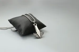 Detailed macro of 316L stainless steel hammer pendant with etched metal textures