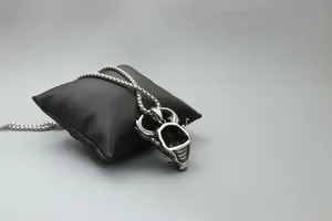 Detailed view of Xenomorph skull pendant in stainless steel with bead chain