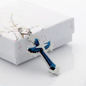 Polished stainless steel cross pendant with blue wings and star on a white gift box