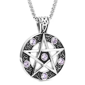 Macro detail of silver pentagram pendant with purple crystals and Celtic knotwork