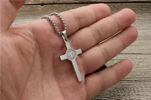 Detailed macro view of silver St. Benedict cross pendant with religious engraving