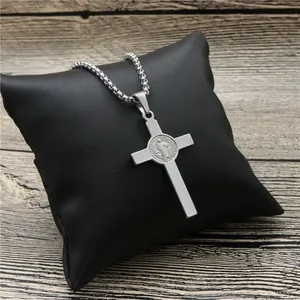 Saint Benedict cross pendant necklace in silver stainless steel on a black cushion
