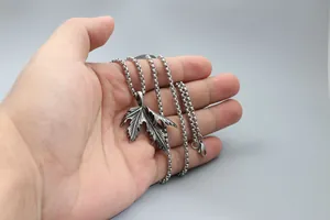 Detail of vintage maple leaf pendant in darkened titanium steel with sturdy box chain