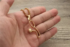 Detailed view of a gold-plated stethoscope pendant necklace on a sturdy box chain