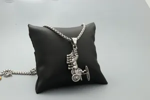 Détail d'un pendentif de char en argent sur présentoir en cuir avec texture rétro