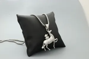 Macro detail of silver horse pendant with a leaping animal on thick metal chain