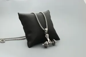 Detailed close-up of a silver weightlifting dumbbell pendant with a sturdy box chain