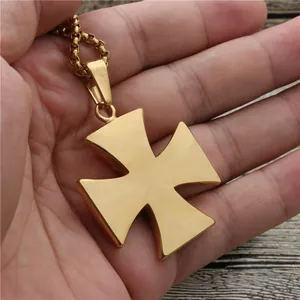 Golden Maltese cross pendant necklace with box chain held in hand for size display