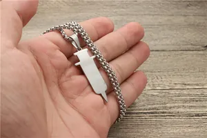 Detailed view of silver stainless steel syringe pendant on a classic box chain necklace