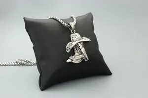 Detailed close-up of cowboy hat and boot metal pendant with vintage silver finish