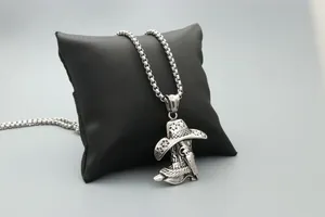 Detail of vintage cowboy hat and boot pendant necklace with a textured silver finish